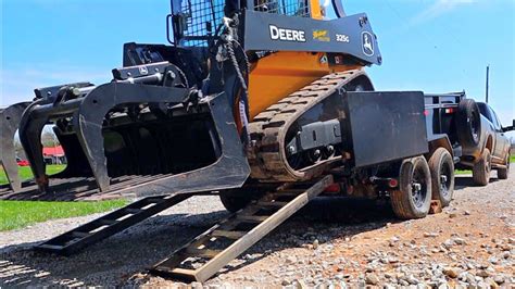 loading a skid steer on a dump trailer|skid steer in dump trailer.